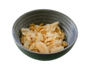 Unsweetened, toasted coconut chips in a blue bowl