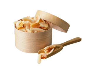 Toasted Coconut Chips in a wooden bowl besides a wooden spoon with Toasted coconut chips