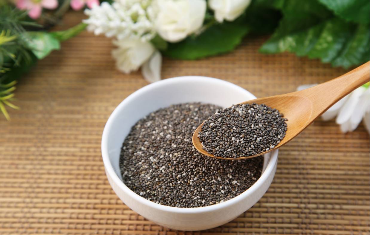 Chia Seeds in a bowl scooped with a spoon.