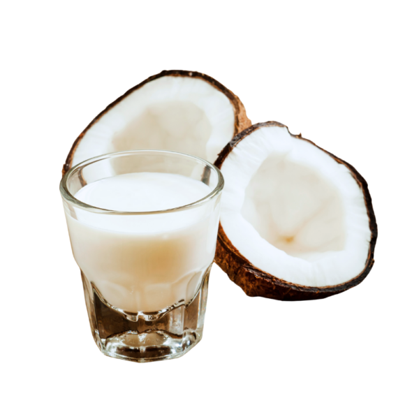Coconut milk on a glass beside 2 coconuts