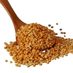 Red lentils in a wooden spoon