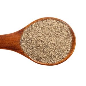 Black ground pepper on a wooden spoon