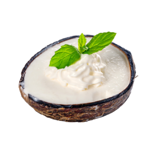 Coconut cream in a coconut shell used as a bowl, garnished with a mint leaf.