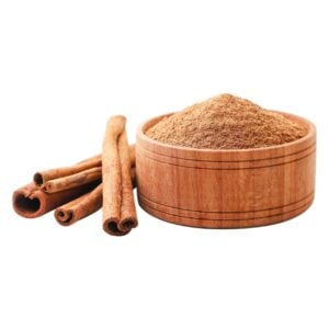 Brown cinnamon powder in a wooden bowl next to three cinnamon sticks.