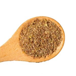 Crushed flaxseeds on a wooden spoon