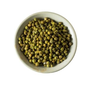 Whole green peppercorn in a white bowl