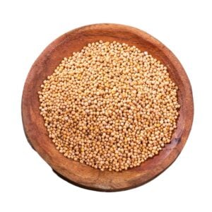 Yellow mustard seeds in a brown bowl.