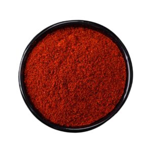 Reddish brown powder in a black bowl.