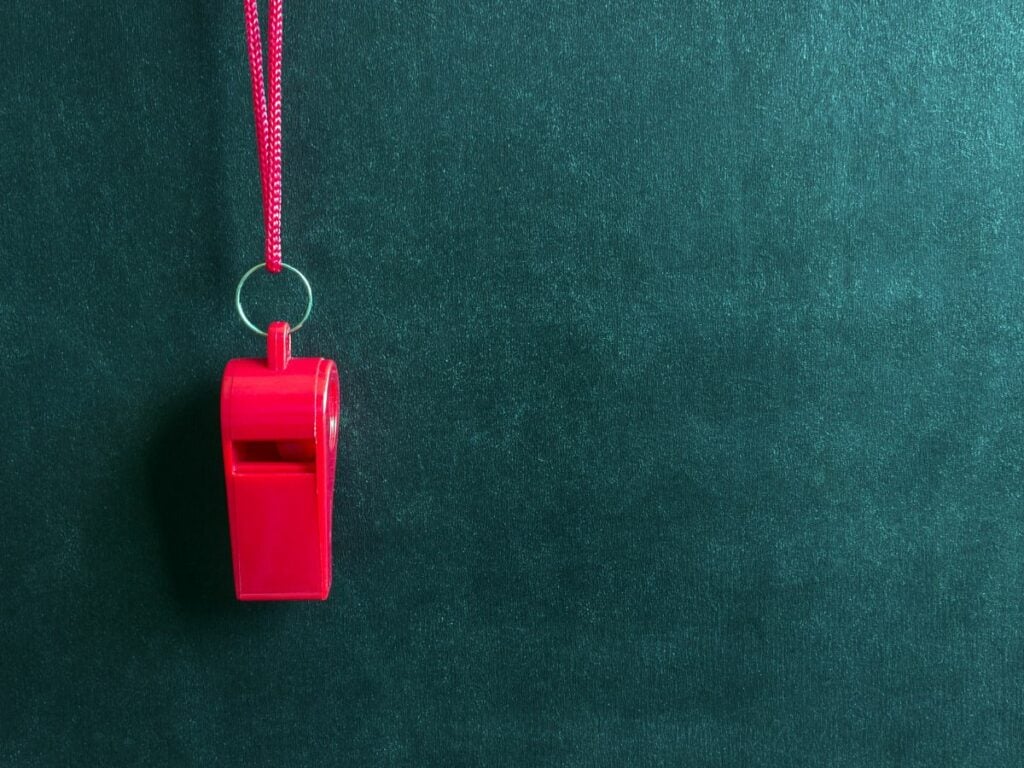 Red whistle on a green background