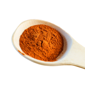 Reddish powder in a wooden spoon.