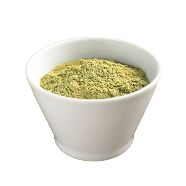 Green powder in a white bowl.