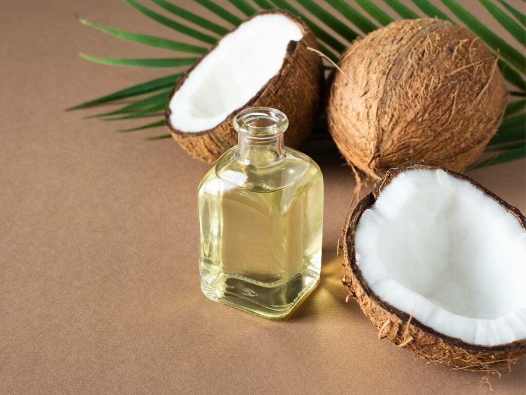 coconut oil and a bowl of coconut oil on a white wooden table