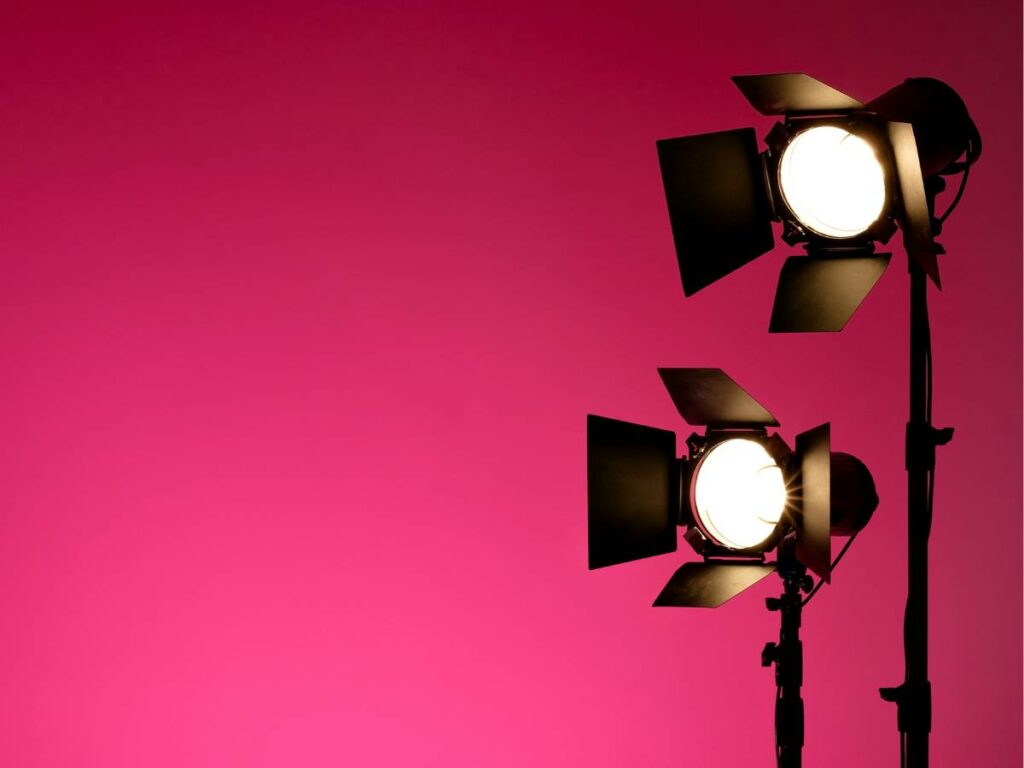 two lights in front of a pink background