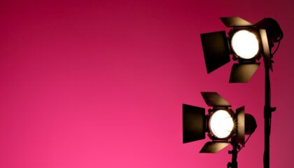 two lights in front of a pink background