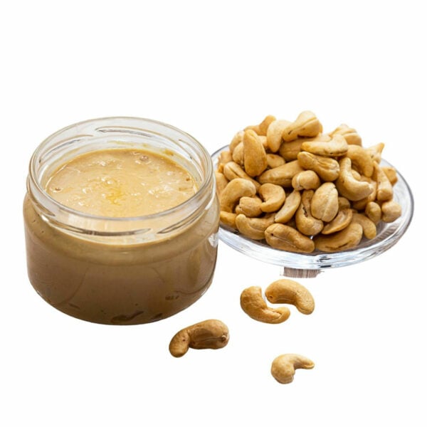 Cahew Butter in a jar beside some cashew nuts