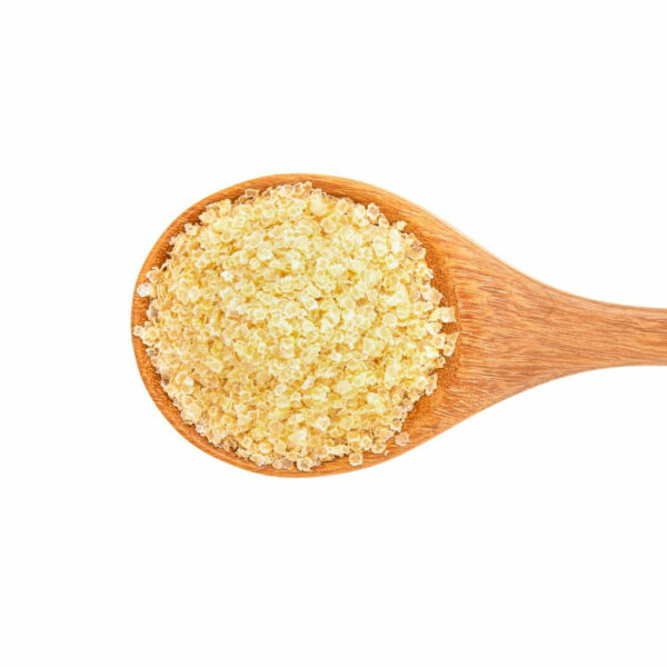 Golden colored flakes on a wooden spoon showed from the top view