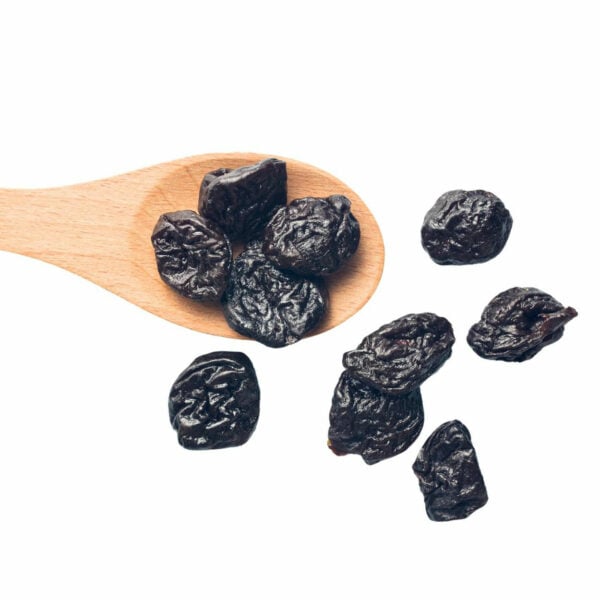 Dried Prunes displayed with a wooden spoon.