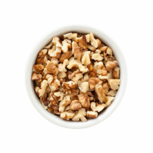 Top view of diced walnuts in a bowl.