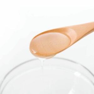 Clear Syrup on a wooden spoon