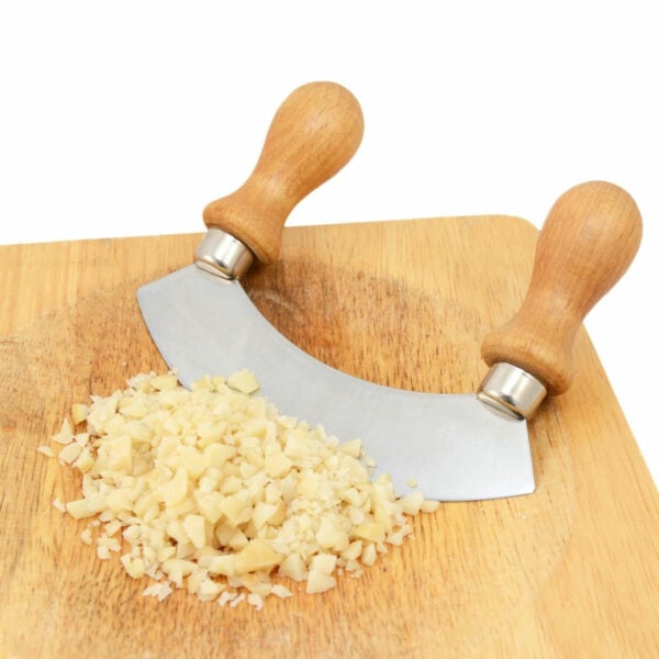 Chopped nuts on a chopping board beside a knife.