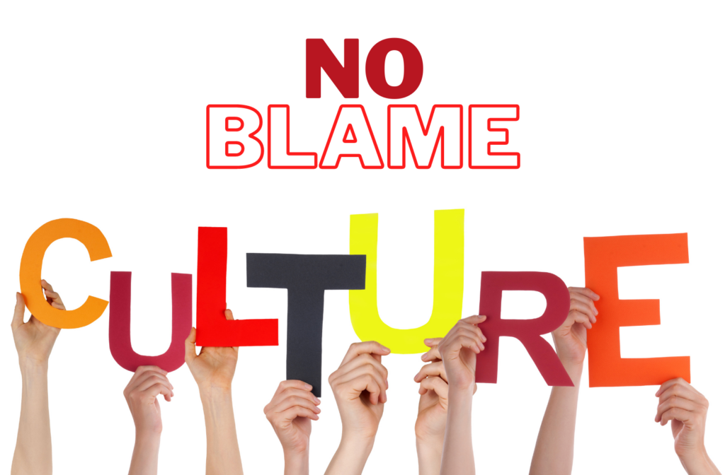a group of hands holding up the word "no blame culture"