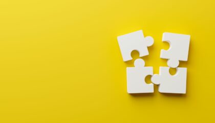 four pieces of puzzle on a yellow background