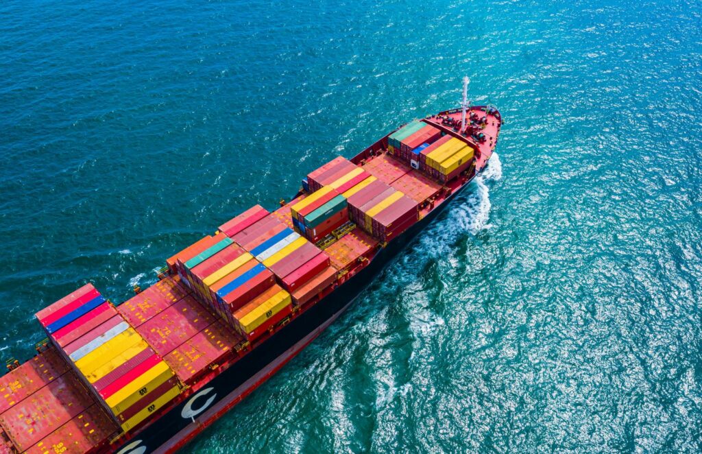an aerial view of a container ship in the ocean
