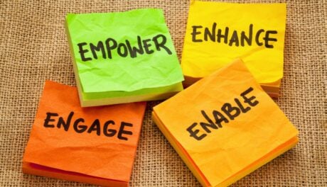 Post Its that say empower, empower, engage, enable