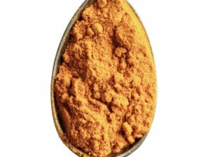 Orange powder displayed in a spoon.