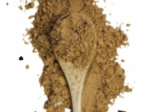 Top view of brown powder displayed on and around a wooden spoon.