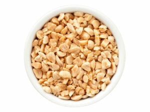 Top view of crushed peanuts in a bowl.