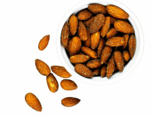 Golden almond nuts in a bowl.